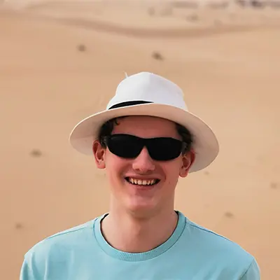 Profile picture of Tim wearing a white hat and sunglasses