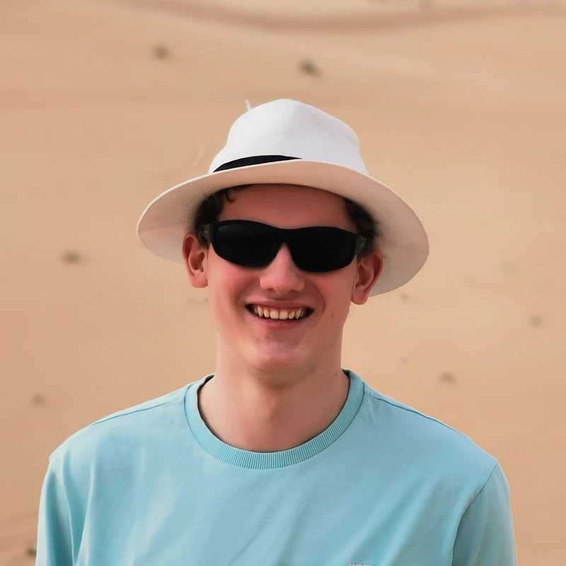 Profile picture of Tim wearing a white hat and sunglasses